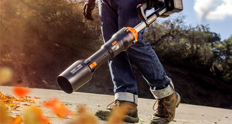 A person with their hand in front of the WorxNitro Leaf Blower feeling the powerful gust of wind.